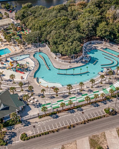 Aerial view of Sandy Harbor Family Fun Center showing the winding Adventure River, pools, and slides